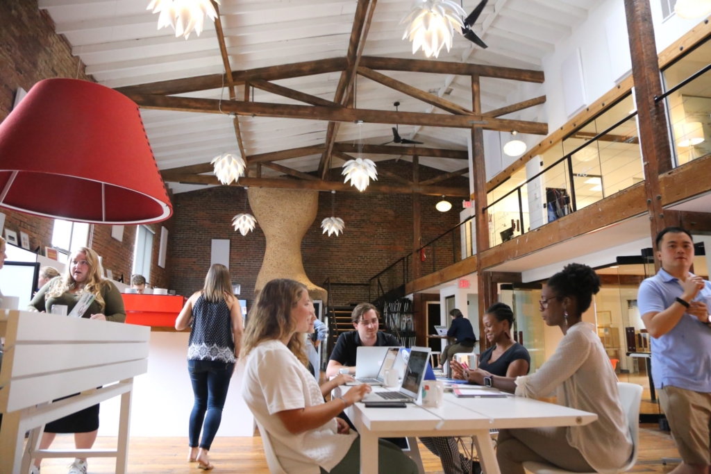 HQ Raleigh people HQ Raleigh indoor space with various professionals working and hanging out.
