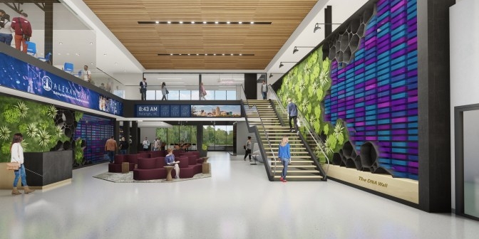 Wide open lobby at Alexandria Center for AgTech. A standout feature is the DNA wall lining the lobby, containing colored sequences and patterns.
